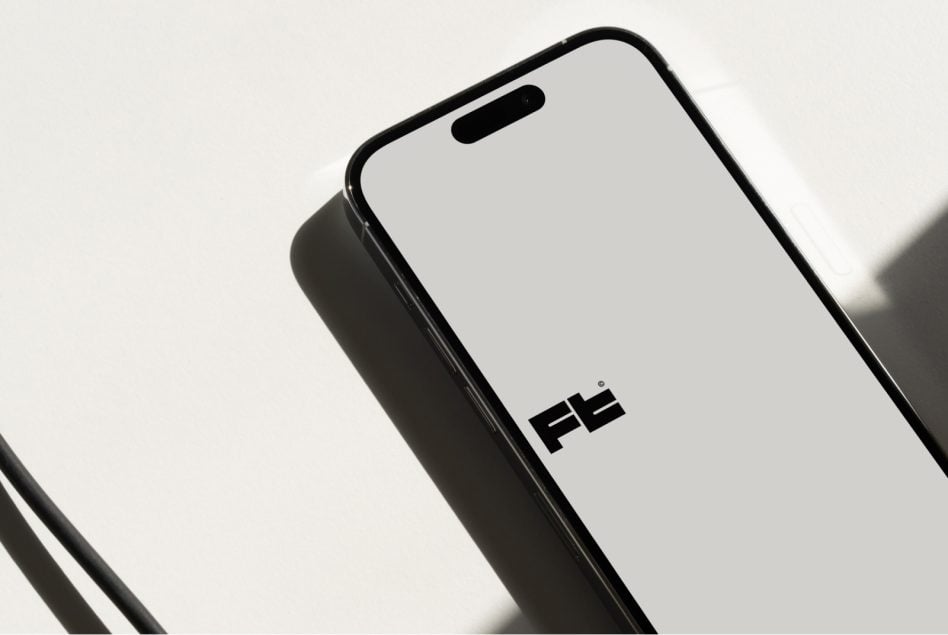 Phone mockup tilted at angle showing notch cutout against minimal backdrop